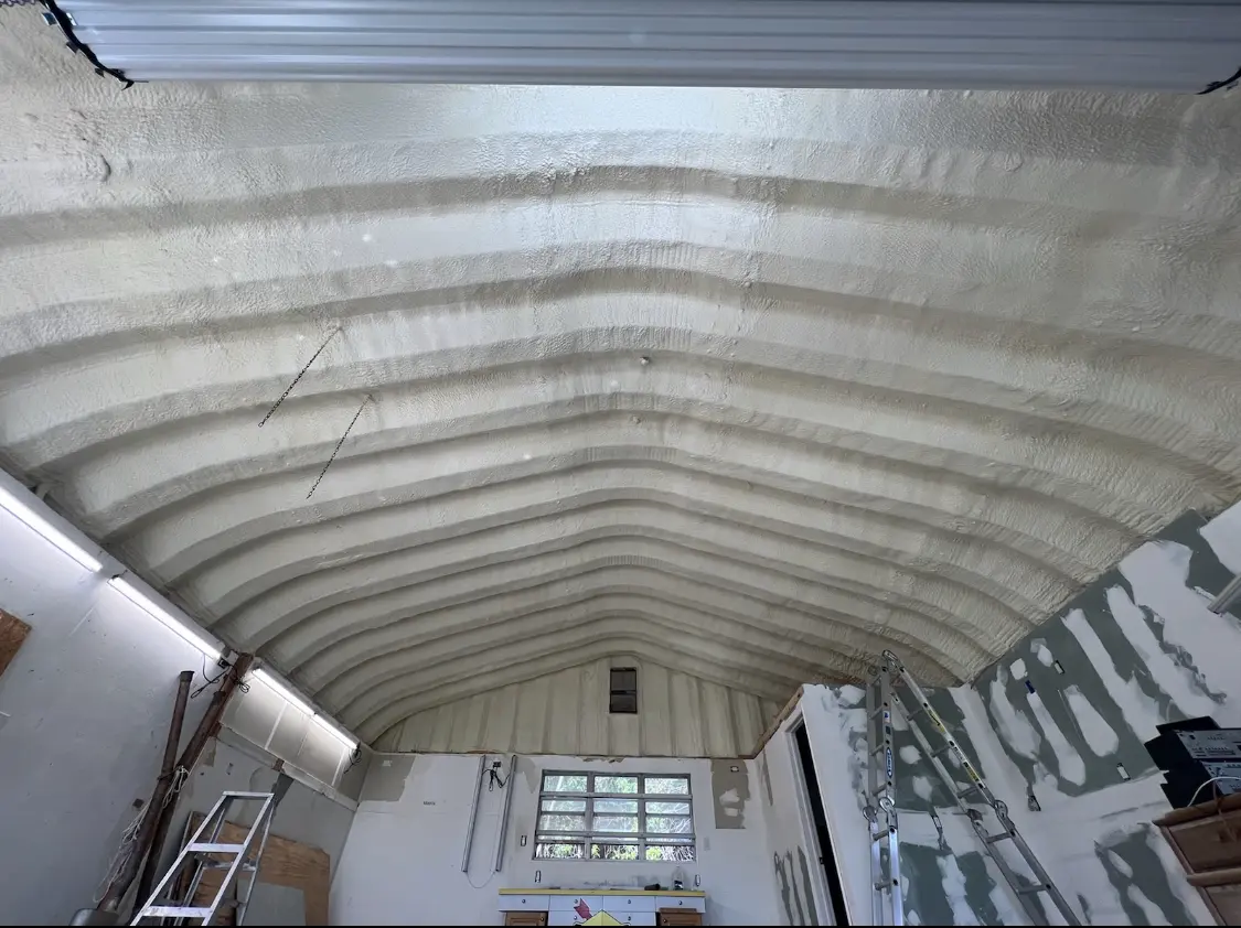 Spray polyurethane foam applied to the underside of a metal roof deck in Waggaman